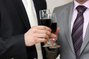menu holding wine glasses at corporate charter
